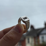 Image of Sam Ozanne Design's Silver Casio Ring Being Held