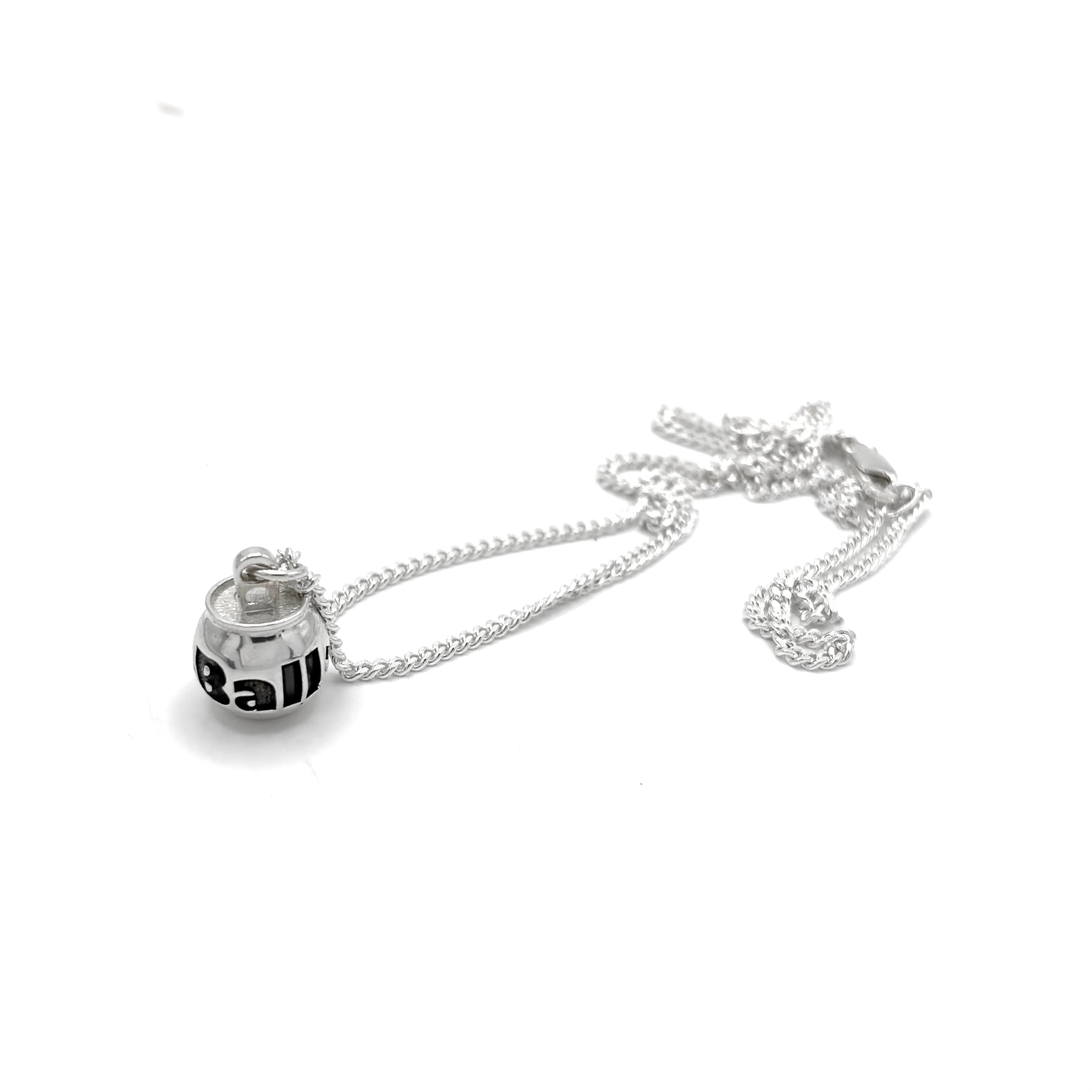 A silver chain necklace with a small cocktail can pendant featuring the word 'BuzzBallz' printed in bold black letters, shown on a white surface.